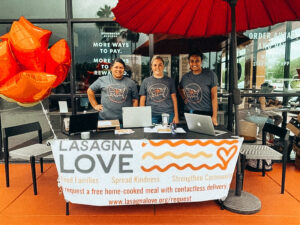 Lasagna chefs hand out meals outside of starbucks