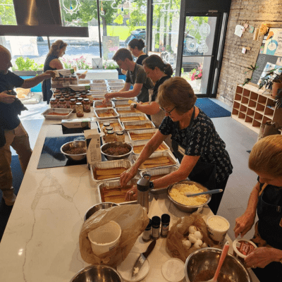 Volunteers cooking lasagna together